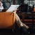 a person sitting down in a chair reading something