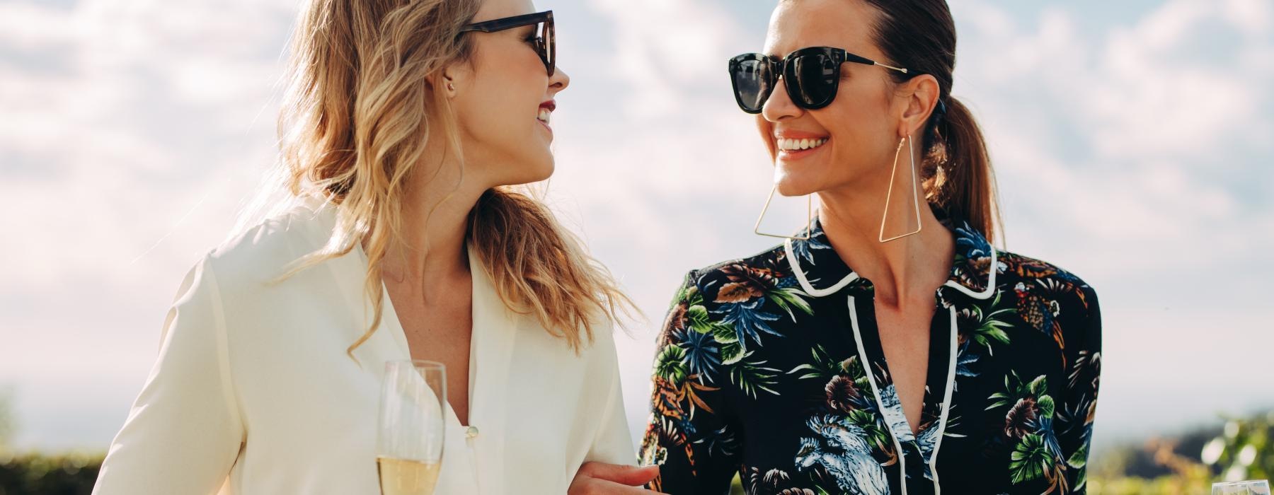 a couple of women holding wine glasses